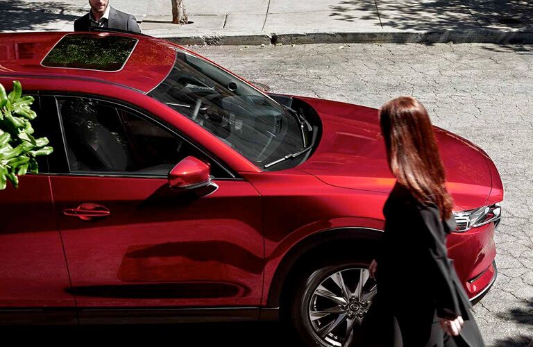 woman walking by parked CX-5