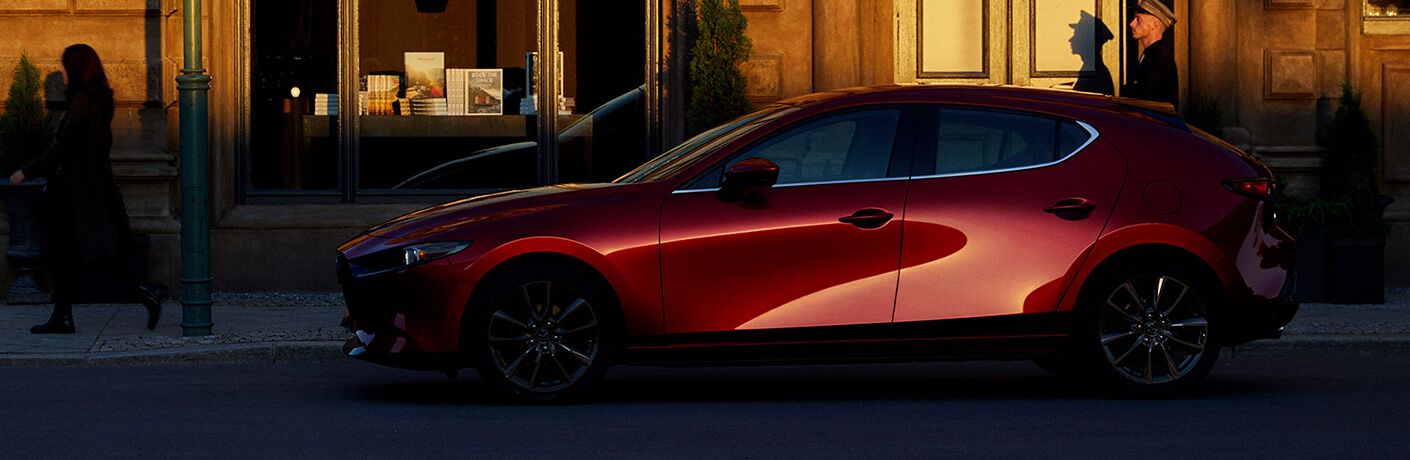 left side view of red mazda3 hatchback