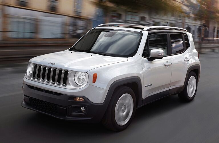 2019 Jeep Renegade exterior shot with white paint color driving through a city