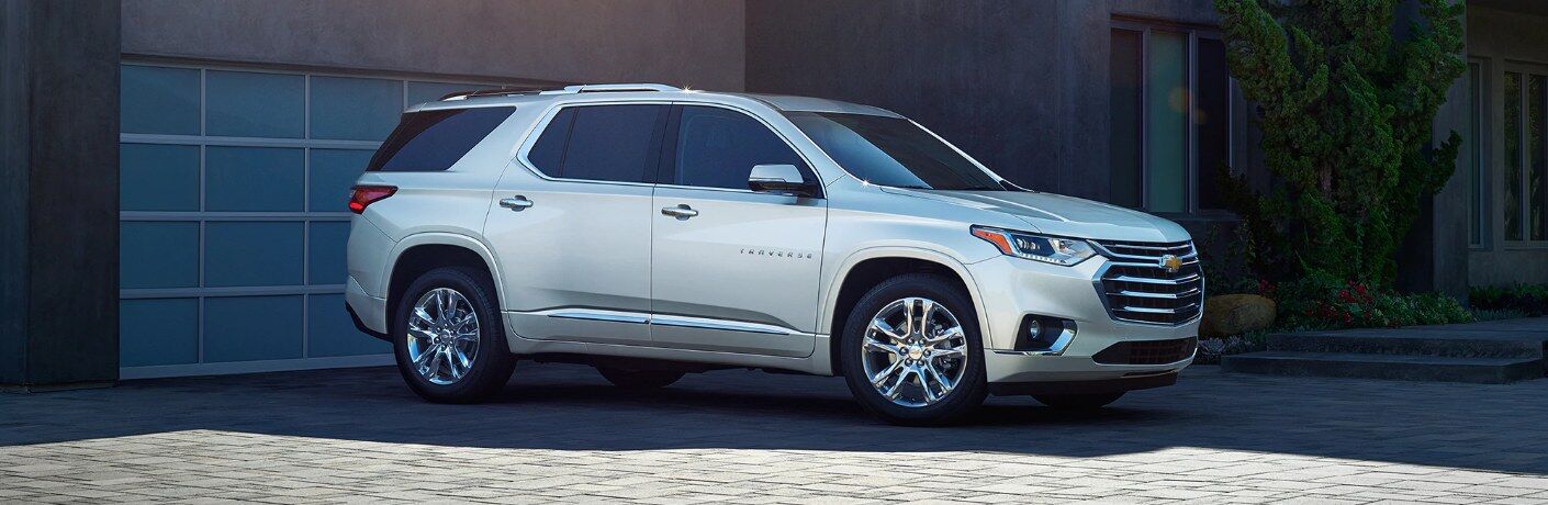 Front passenger angle of a white 2020 Chevrolet Traverse parked in a driveway