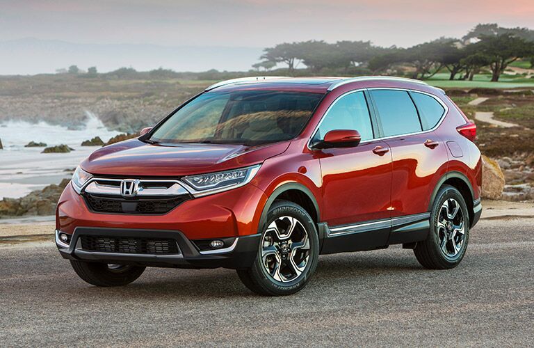 2019 Honda CR-V exterior front fascia and driver side next to lake with trees in distance
