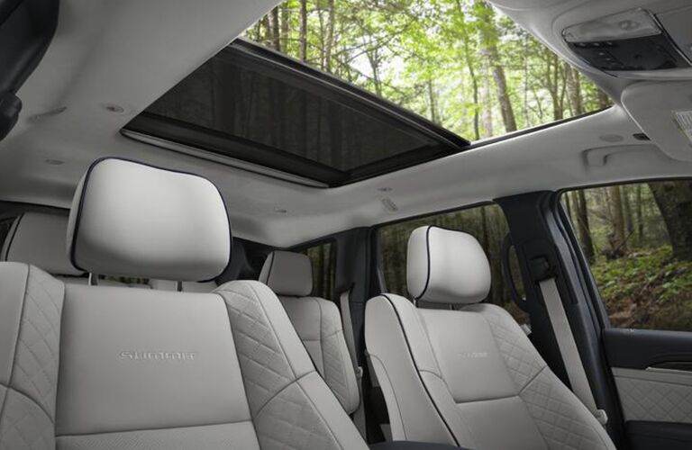 2020 Jeep Grand Cherokee interior shot showing dual pane sunroof retracted and front cloth seats