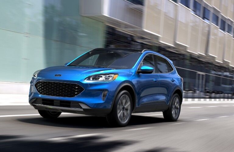 Front driver angle of a blue 2020 Ford Escape driving in the city