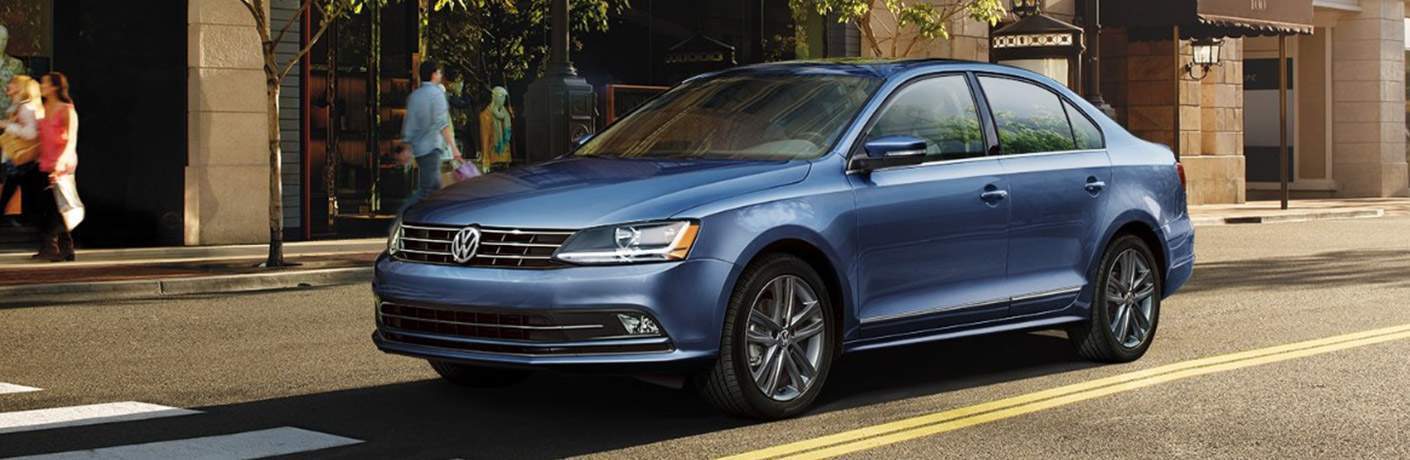 Blue 2018 Volkswagen Jetta stopped at a crosswalk
