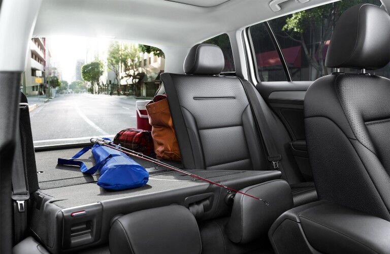 View from front passenger seat of the rear seat put down and fishing gear loaded inside the 2019 Volkswagen Golf SportWagen